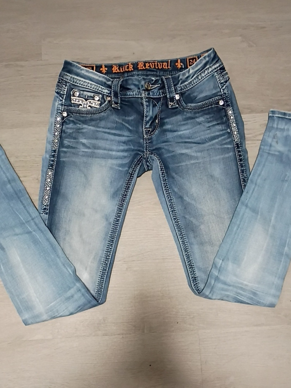 Rock Revival Women’s Faded Blue Skinny Jeans with Embellished Pockets